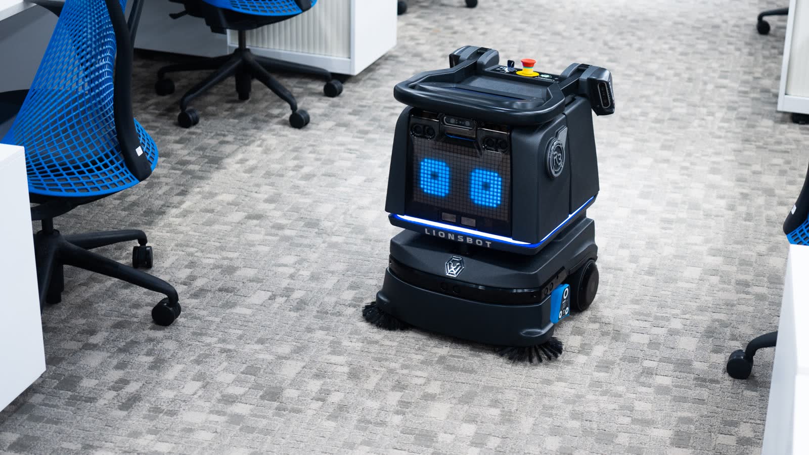 A LionsBot R3 Vac autonomous vacuum robot working a carpeted floor