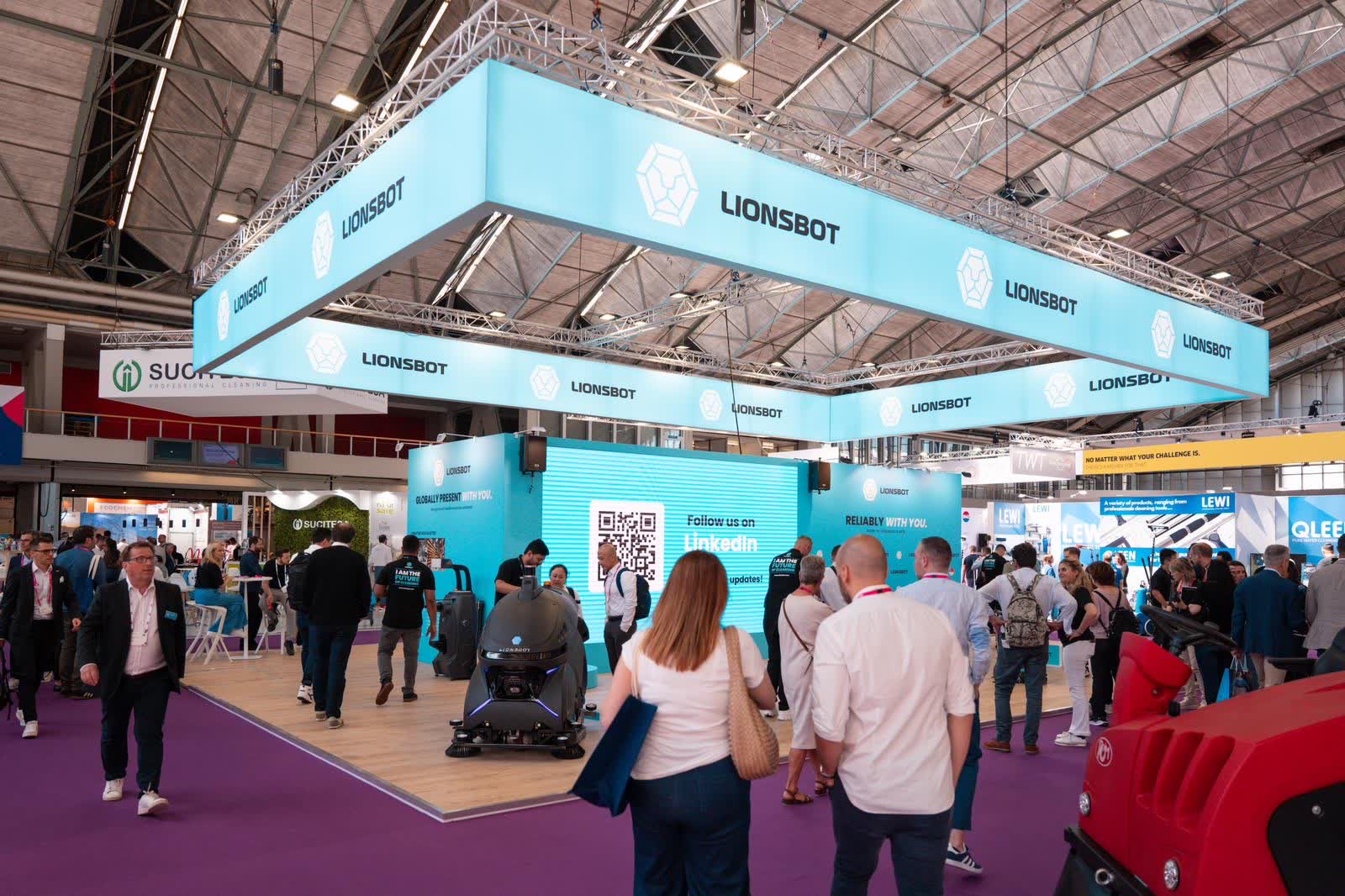 The LionsBot stand at Interclean Amsterdam 2024, a large branded canopy above a busy show floor
