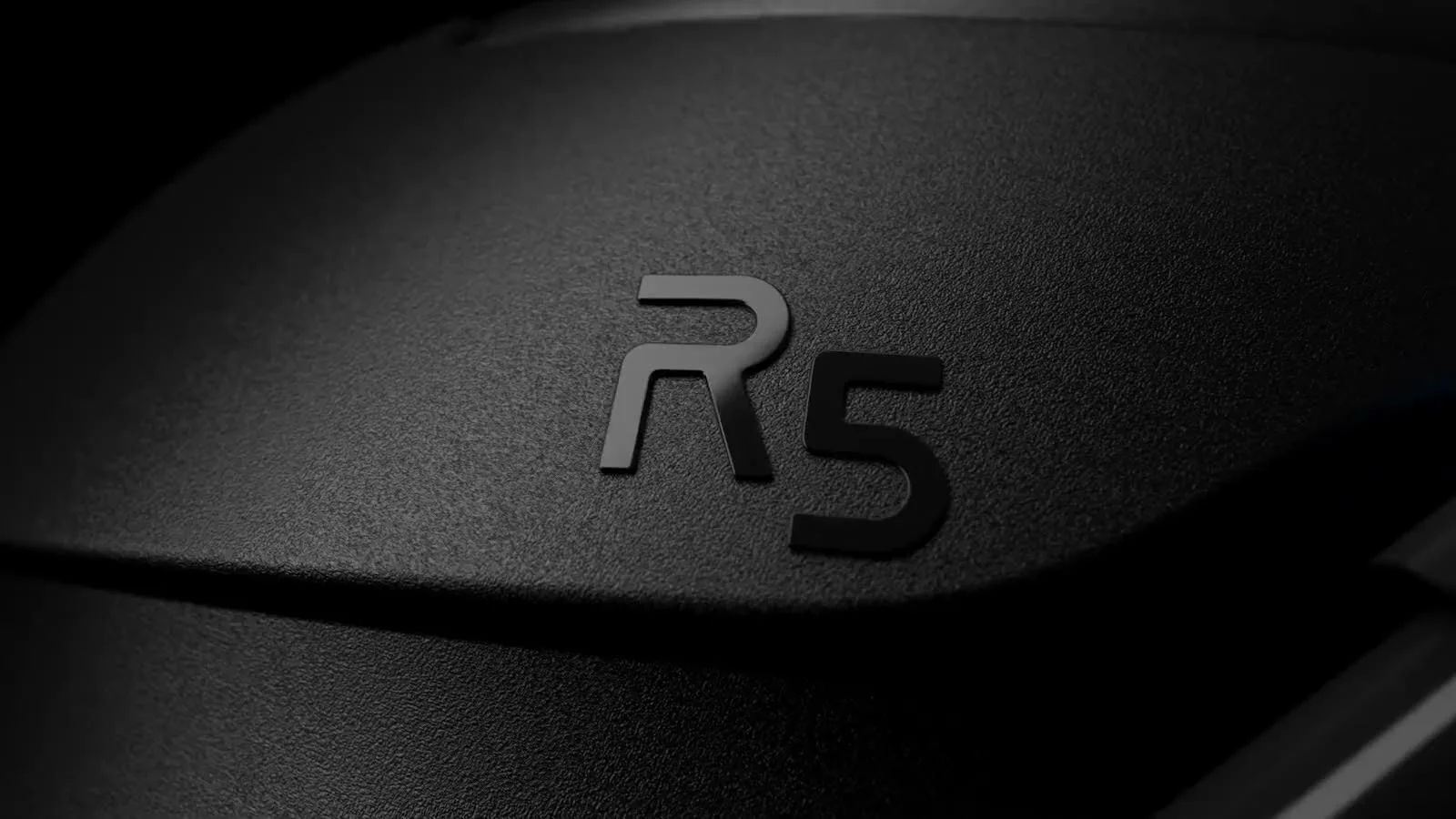 A close view of the R5 badge on the machine shell, lit from above